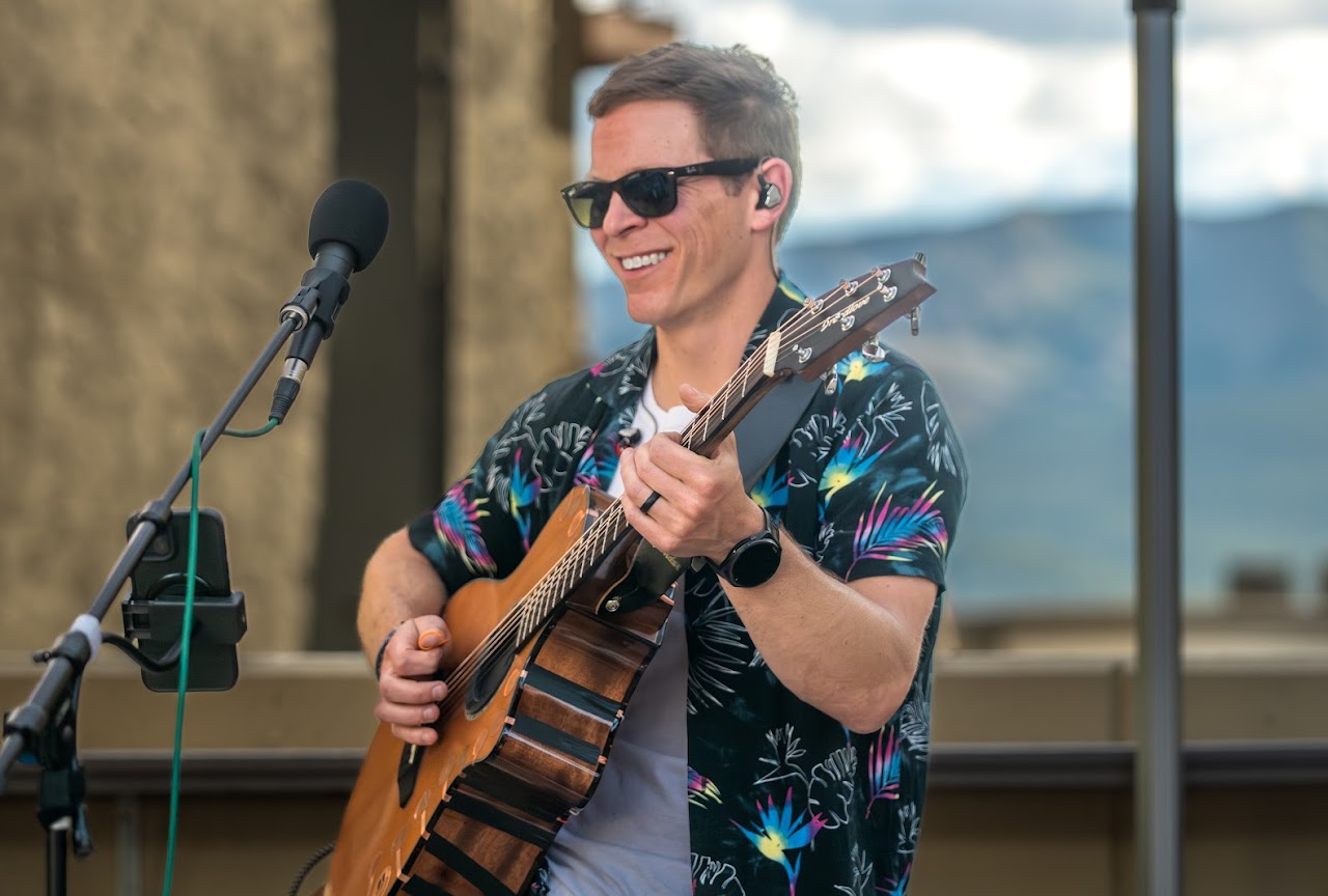 Emory Capps playing guitar live with Strand Hill Music in Crested Butte